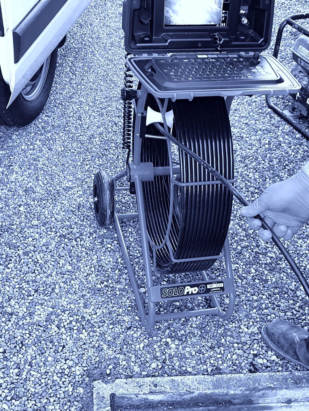 Cofton DJS drain inspection camera reel and monitor beside a service van and access chamber